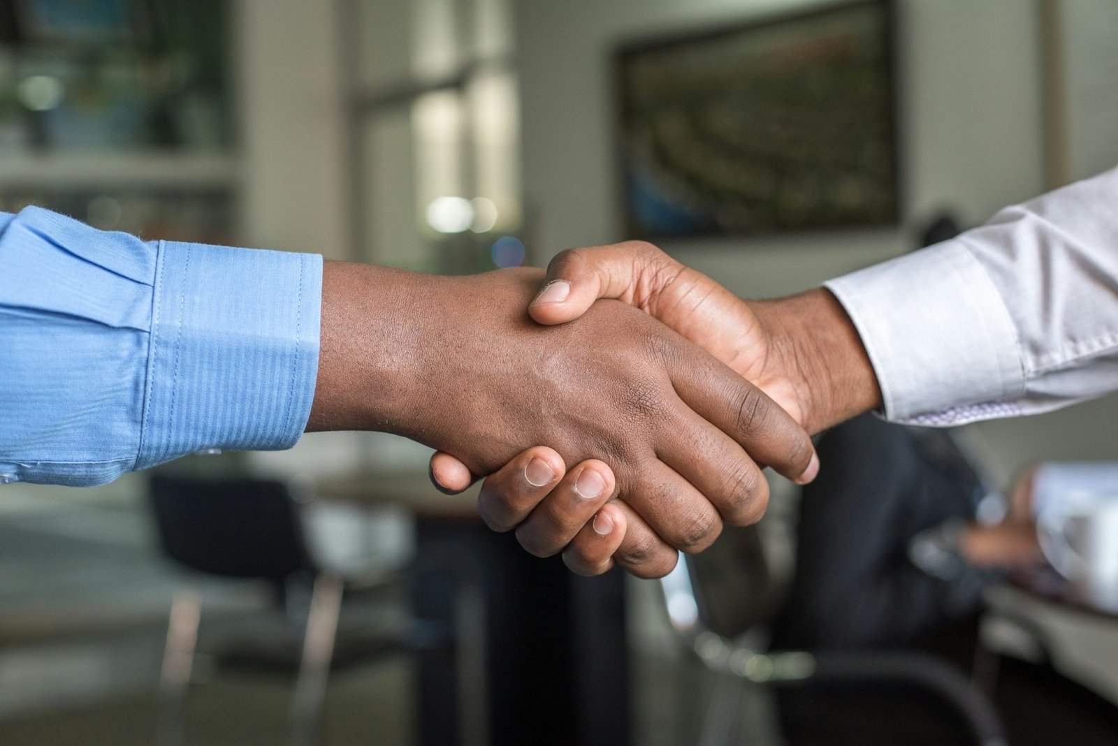 Two investors shaking hands on a deal
